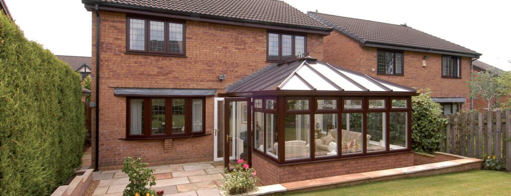 Conservatory with white uPVC frames on a brick house
